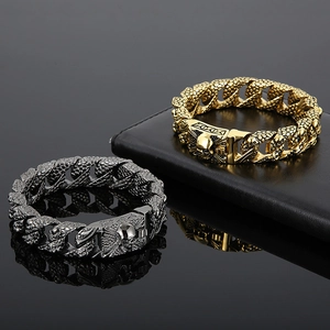 Detail of heavy punk skull clasp bracelets with golden and grey snake scale texture