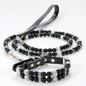 Detail of luxury pearl pet collar with silver rhinestone ball and black leather leash