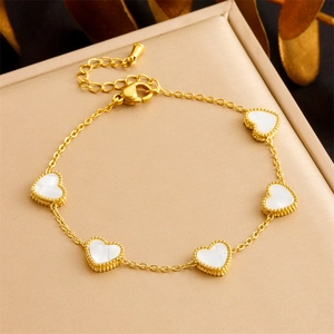 Gold-plated stainless steel chain bracelet featuring white mother-of-pearl heart charms