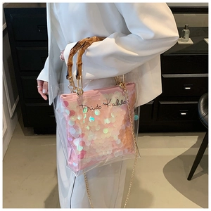 Detail of transparent PVC bag with bamboo-style handle and pink sequin inner pouch