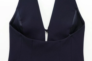 Close-up of navy blue halter top featuring a V-neckline and woven fabric texture