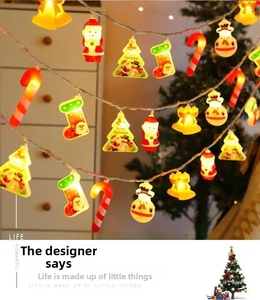 Detail of warm white LED Christmas lights with Santa, snowman and tree figurines
