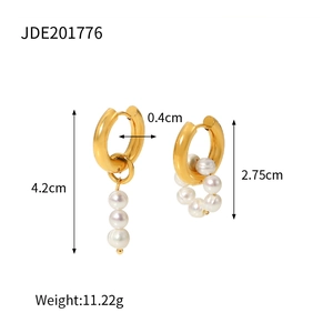 Detailed view of asymmetric gold stainless steel hoop earrings with natural freshwater pearls