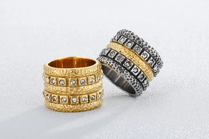 Detail of mixed-metal hammered stainless steel rings with sparkling zircon inlay