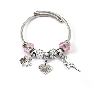 Detail of silver wire bracelet with pink beads, butterfly, heart, and fairy charms
