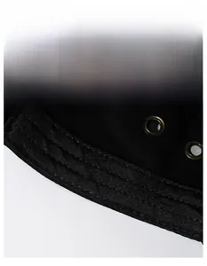 Close-up of internal sweatband and metal ventilation eyelets on a black cotton army cap
