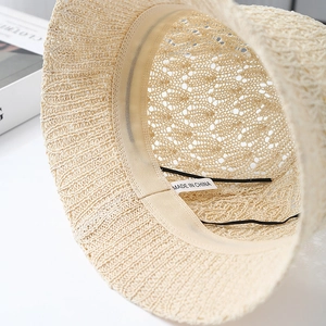 Detail of the knit bucket hat interior featuring an adjustable drawstring and sweatband