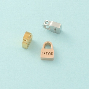 Detailed view of heart-shaped Love lock charms in gold, silver, and rose gold finishes