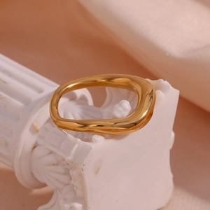 Minimalist 18K gold plated stainless steel irregular lava ring on a decorative pillar
