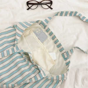 Internal view showing the large capacity and storage pockets of this striped canvas tote bag