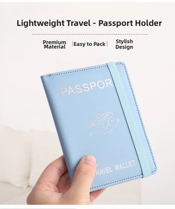 Close-up of light blue PU leather passport cover with rose gold engraving and elastic band