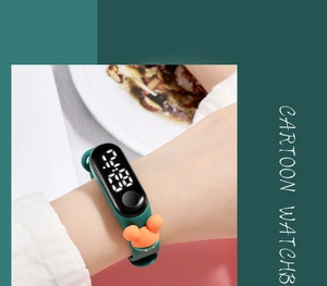 Detail of cartoon LED digital watch with dark green silicone strap and orange bear icon
