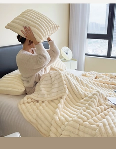 Detail of soft cream faux rabbit fur blanket with luxury wide striped texture