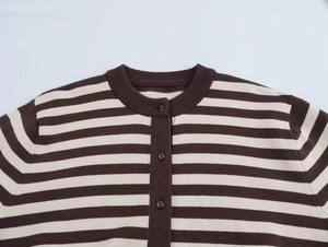 Detail of round neckline and buttons on striped knit cardigan in brown and beige