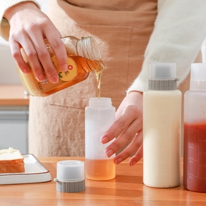 Transparent plastic squeeze bottle with 5-hole nozzle and measurement scales for sauce