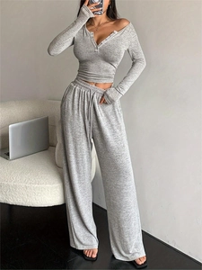 Close-up of heather grey long sleeve crop top with buttoned V-neck and ribbed texture