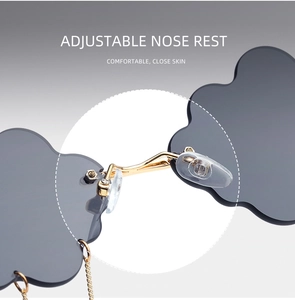 Close-up of adjustable clear nose pads on cloud-shaped rimless sunglasses with gold chain