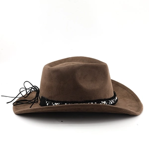 Detailed view of brown suede cowboy hat with black and white woven ribbon and metal beads