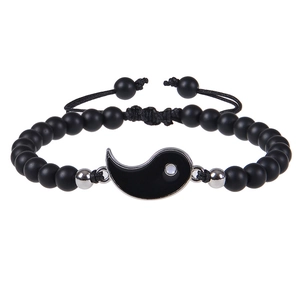 Detail of adjustable woven cord bracelet with matte black beads and Yin Yang charm