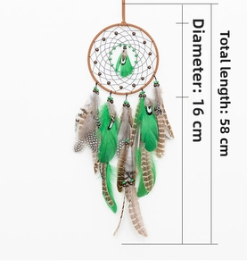 Detail of bohemian dream catcher with brown weave and green striped feathers, size 16x58cm