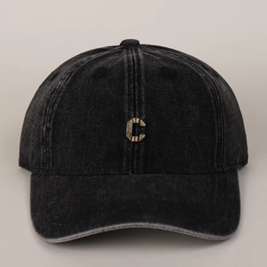 Detailed view of metal C letter and distressed washed cotton denim baseball cap texture