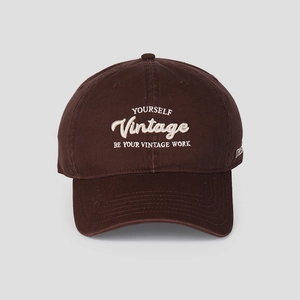 Close-up of vintage 3D letter embroidery on a dark brown cotton baseball cap