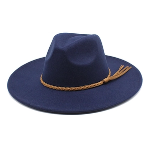 Detailed view of navy blue wool fedora featuring a braided brown leather trim with tassel
