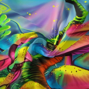 Detail of bohemian tapestry featuring vibrant abstract mushroom patterns and soft fabric