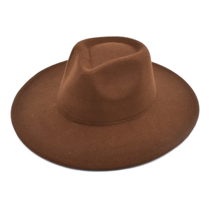 Detailed view of the brown wide-brim felt fedora hat with a classic teardrop top crown
