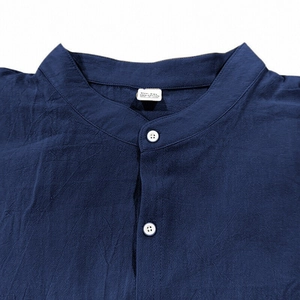 Detail view of navy blue cotton shirt stand collar and fabric texture on white background