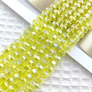 Macro shot of 8mm faceted lemon yellow glass beads with iridescent AB coating for jewelry DIY