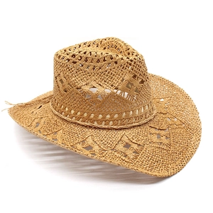 Detailed close-up of geometric hollow-out weave on natural straw cowboy hat