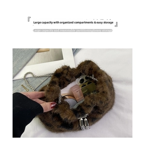 Detail showing the spacious interior of a leopard print plush bucket bag with chain strap