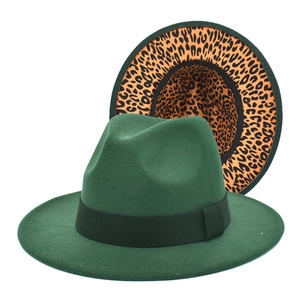 Detail of dark green wool fedora with black ribbon and leopard print lining