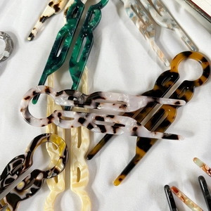 Elegant U-shaped acetate hair pins in marble and tortoiseshell patterns for buns