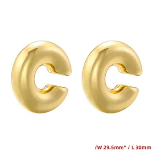Detailed view of chunky 18K gold plated C-shaped earrings with 30mm size measurements
