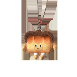 Détail du porte-monnaie toast en peluche avec visage souriant et cordon marron