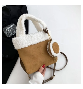 Detail view of brown faux suede handbag with white faux shearling trim and coin pouch