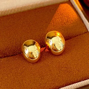 Minimalist gold-plated pebble earrings with a polished mirror finish in a gift box