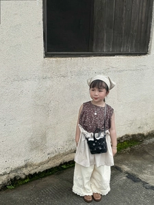 Detail of a vintage retro brown woven shoulder bag for kids in a rural fashion style