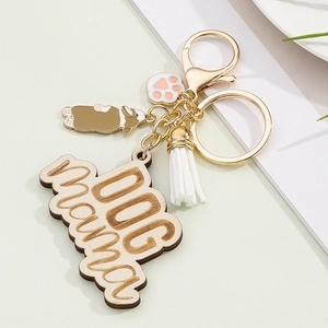Detailed view of Dog Mama keychain with Corgi charm, paw pendant, and white tassel