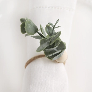 Detail of eucalyptus leaf napkin ring with natural wooden beads and jute rope