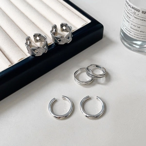 Macro shot of S925 sterling silver rings with woven texture on a minimalist jewelry stand