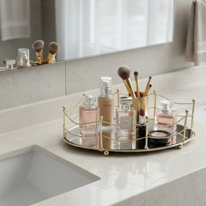 Round mirrored vanity tray with golden geometric metal rails for home decor storage