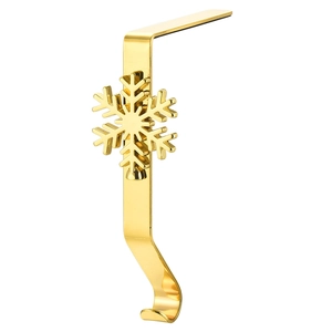 Detail of a gold metal Christmas stocking hook with a snowflake ornament for fireplace