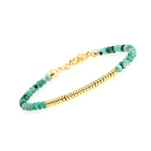 Detail of adjustable gold-plated bracelet with green faceted beads and lobster clasp