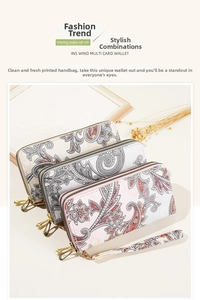 Close-up of paisley print long wallets with dual zippers and matching wrist straps