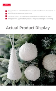 Close-up of white plush foam Christmas ornaments hanging on a green festive tree branch