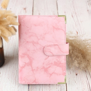 Detail of pink marble PU leather A6 binder cover with elegant golden metal corners