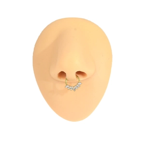 Detail view of gold titanium nose ring with marquise zircon on a silicone model